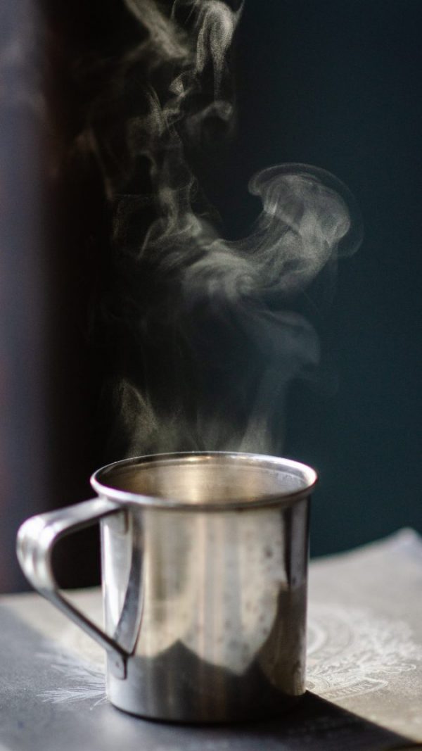 Canva – Grey Stainless Steel Mug Filled With Hot Liquid on Brown Surface