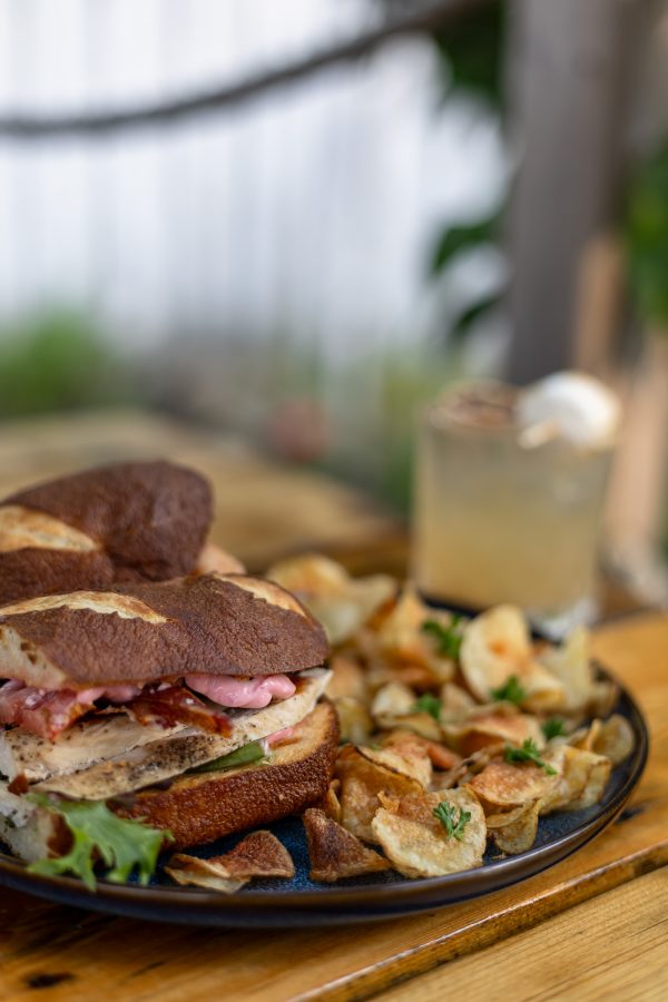 Club sandwich on pretzel bun with pink aioli at The Emerald Light Shelburne